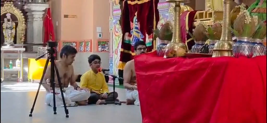 Performers seated on stage